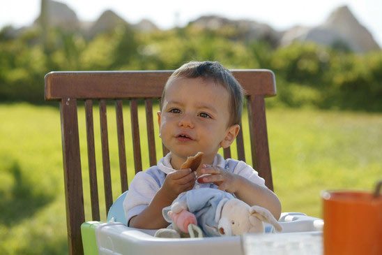 kid-sat-eating-in-high-chair